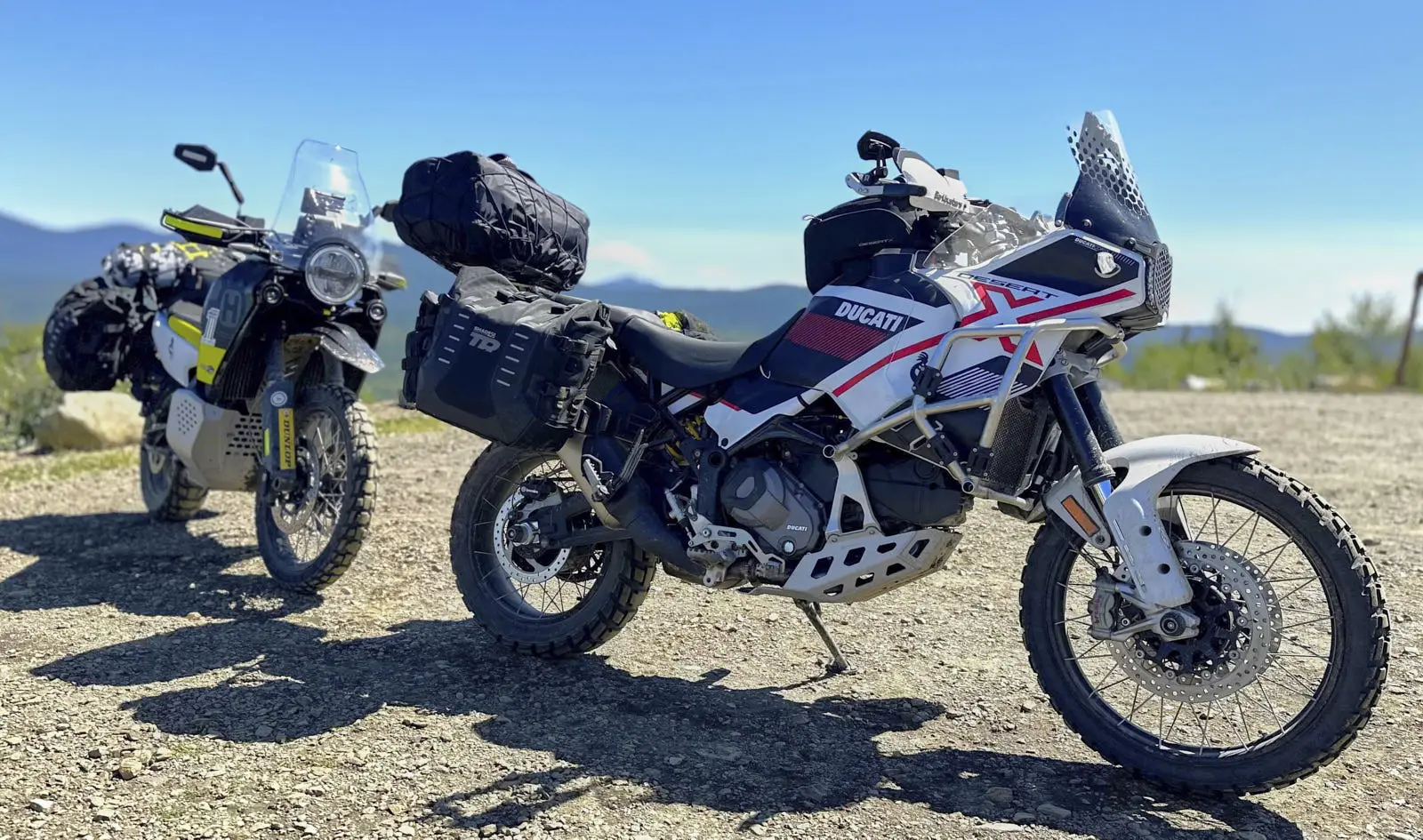 Valise semi-rigide Terra de SHAD, montée sur une Ducati Desert X et une Husqvarva Norden 901.