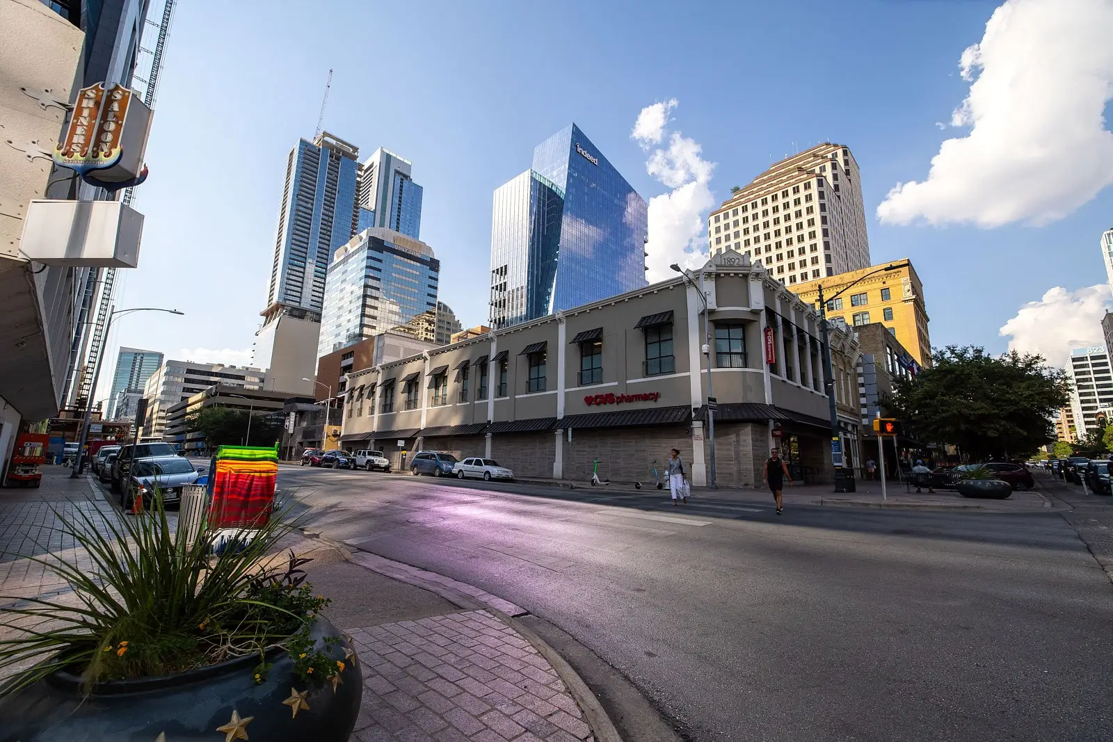 Downtown Austin, Texas, with modern glass buildings and a CVS Pharmacy on the corner of a historic building.